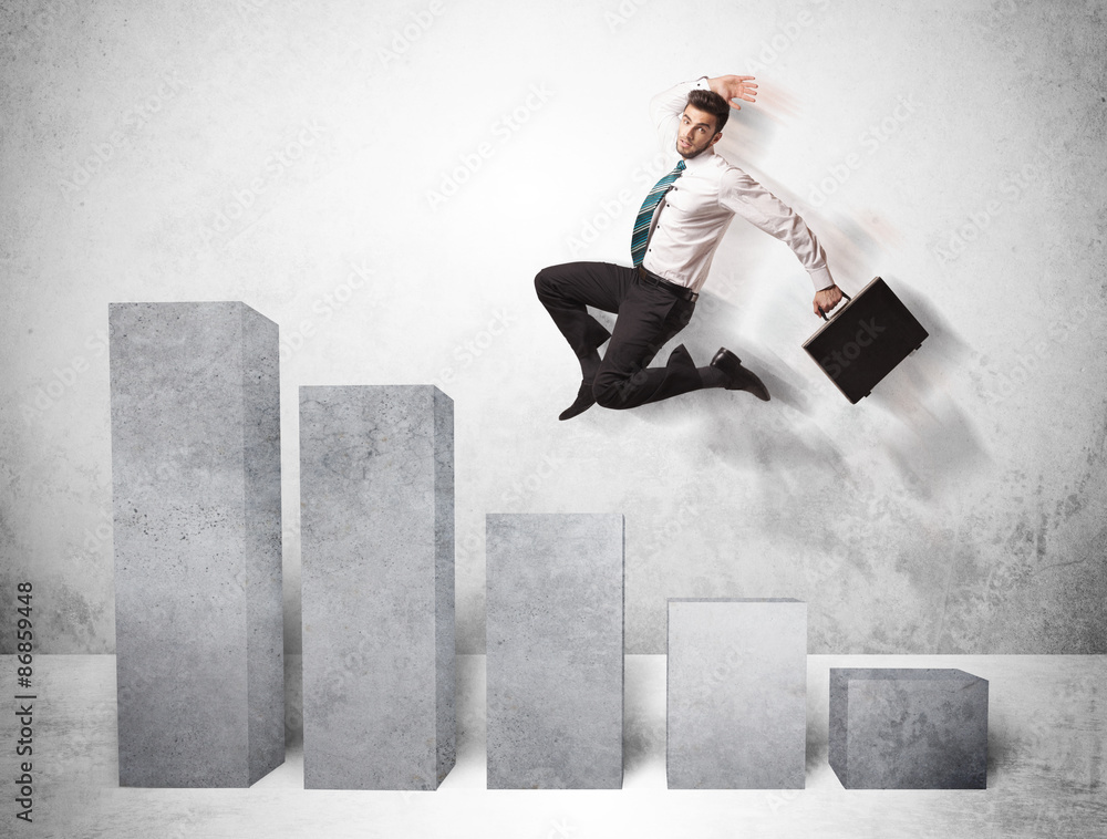 Wall mural Successful business man jumping over charts on background