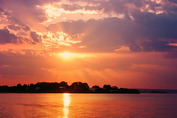 Fototapeta na wymiar Retro Effect Of Summer Sunset With Beautiful Cloudy Sky Over Calm Sea Water