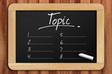 Chalkboard on the wooden table written topic list