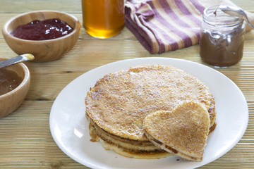 Heart shaped pancake on stack of pancakes