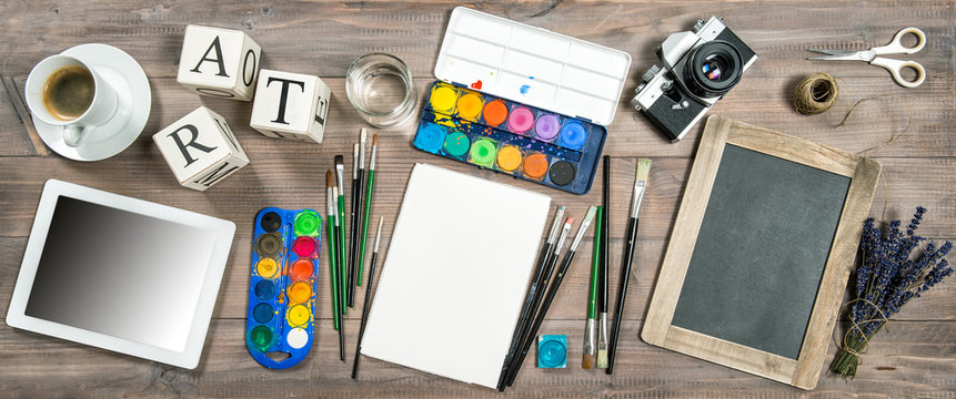 Artistic workplace mockup. Watercolor, brushes, digital tablet,