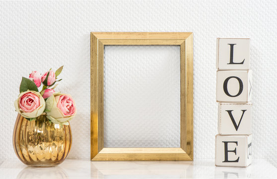 Mock up with golden frame and flowers. Love concept