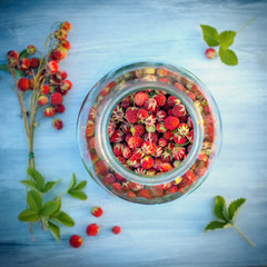 Wild strawberries in a glass jar