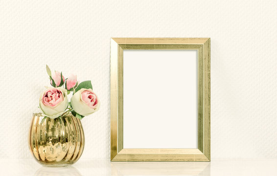 Picture mockup with golden frame amd flowers. Vintage style