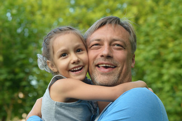 Father with daughter in summer park