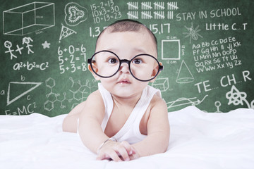 Funny baby with glasses and a doodles background
