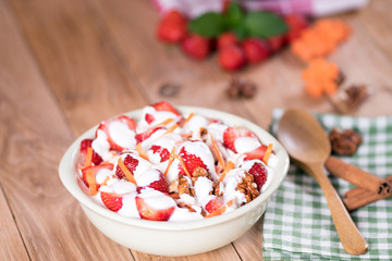 Yogurt with strawberries, carrots, walnuts.