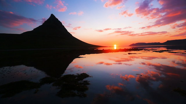 Slow Pan up to Amazing Sunset Reflection on the Water. Kirkjufell

