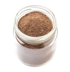 Obraz na płótnie Canvas Dried processed tea leaves in a mason jar over white background