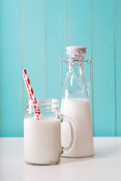 Milk in mason jar with red striped straws