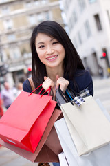 young chinese girl holding shopping bags