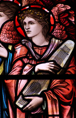 An angel with a music instrument (stained glass)