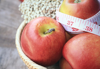 measure tape and apple