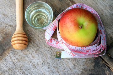 measure tape and apple