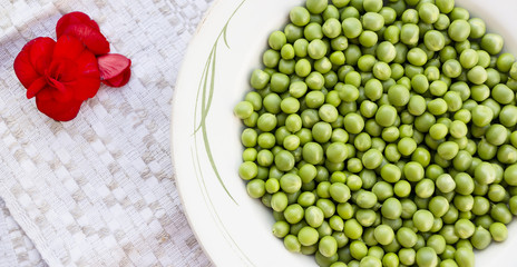 Green peas on the white plate background