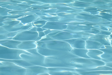 Blue pool water with sun reflections