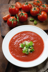 Close-up of gazpacho topped with fresh cucumber and green basil