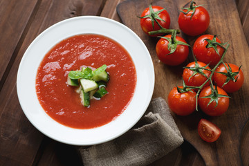 Gazpacho soup with cucumber and green basil topping, studio shot