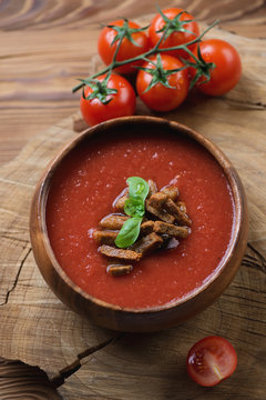 Gazpacho with croutons in a wooden bowl, selective focus