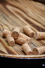 Many wine corks on wood barrel
