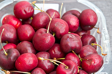 close up of cherry  in a plastic box.