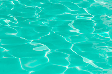 green pool water with sun reflections