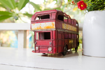 bus toy put on white table in vintage coffee cafe as decoration.