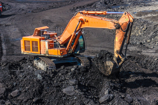 Loading mining trucks an excavator
