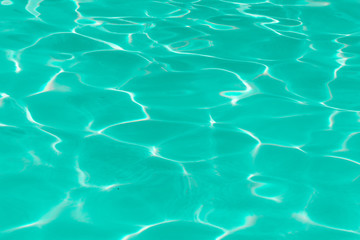 green pool water with sun reflections