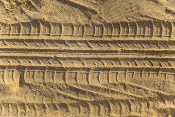 Traces of wheel tread on a sand beach