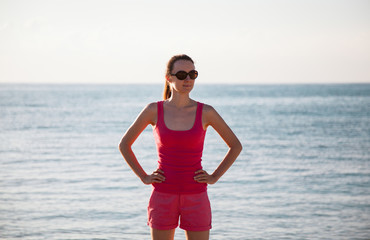 Fototapeta na wymiar Smiling woman standing on the seacoast