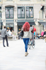 Young shopping women crossing square