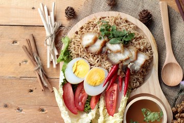 Instant noodles soup put crispy pork and egg
