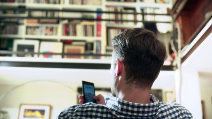 Man sitting in the room and texting on smartphone
- Powered by Adobe