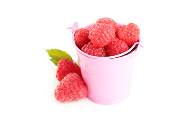 Red raspberry in bucket isolated on a white