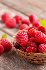 Red raspberries on grey wooden background