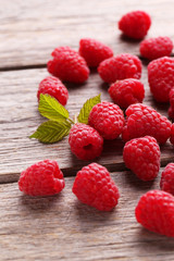 Red raspberries on grey wooden background