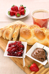 Fototapeta na wymiar Sweet bread breakfast with strawberry jam and chocolate