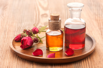 Rose essential oil, flowers and petals rose.  Horizontal.