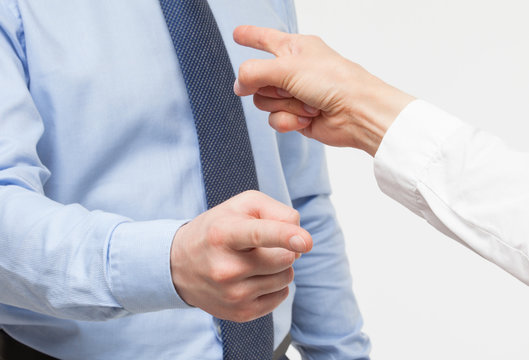 Businessmen's fingers point to each other