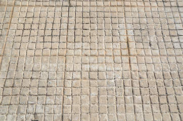 Old floor small tiles beige stone pavement