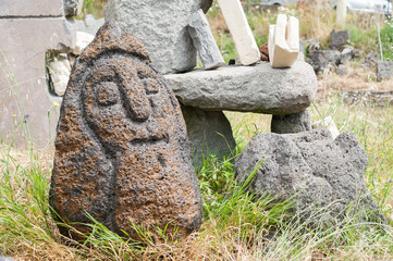 Lava stone sculpture of an old man poured with water to make its design stand out