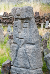 Grey lava stone sculpture of an old king