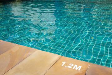 Hotel swimming pool with sunny reflections
