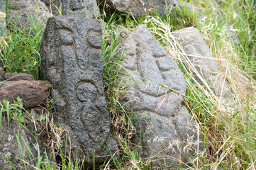 Lava stone sculpture of an old man poured with water to make its design stand out