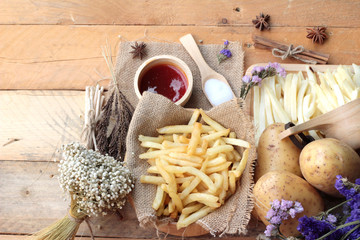 French fries and fresh sliced potatoes with ketchup.