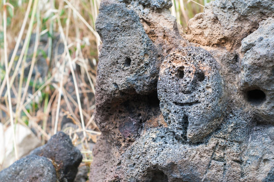 Lava stone sculpture of a stylised man's face