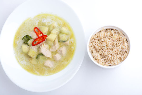 Chicken green curry with rice on white