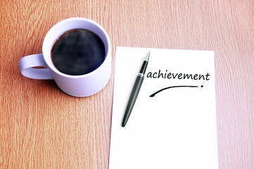 Coffee, pen and notes write achievement