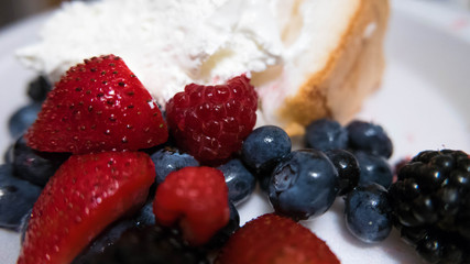 Fruit Shortcake American. Shortcake with strawberries, blueberries, raspberries, blackberries and whipped cream. 4th of July, red white and blue American style.